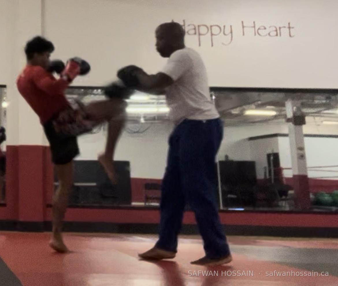 Safwan striking pads with coach Claude Patrick